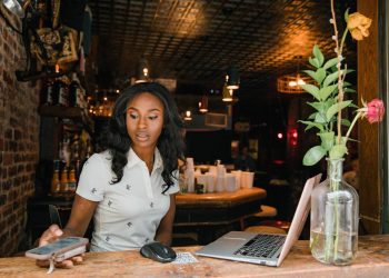 Black woman everyday worker influencer sitting at desk