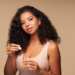Black woman using a hair growth oil.