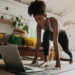 Black woman doing an at-home workout, building muscle in the comfort of her living room.