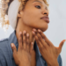 Black woman moisturizing her neck for anti-aging
