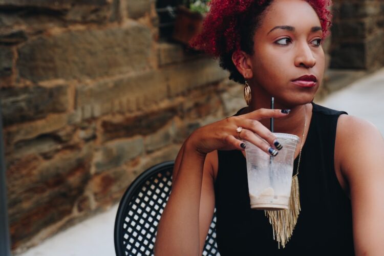 Black woman sitting at table alone after being ghosted.