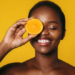 Black woman with beautiful skin using citrus orange