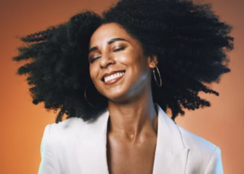 Black woman with natural hair wearing black-owned hair products
